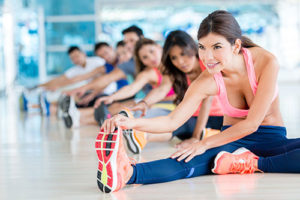 Group of fit people at the gym stretching